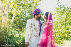 Indian groom and Indian bride sharing a moment in the garden Indian groom and Indian bride sharing a moment in the garden