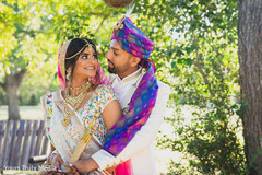 Indian groom holding his Maharani from behind at the yard Indian groom holding his Maharani from behind at the yard