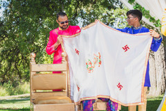 Indian relatives holding the antarpat in front of the Indian groom Indian relatives holding the antarpat in front of the Indian groom