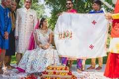 Indian bride sitting on the wedding stage with the Indian groom hidden Indian bride sitting on the wedding stage with the Indian groom hidden