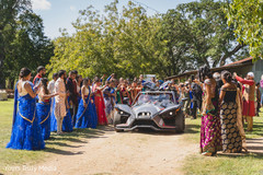 Indian newlywed couple leaving the wedding yard in a sports car Indian newlywed couple leaving the wedding yard in a sports car