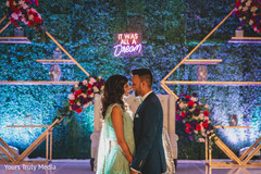 Newlywed Indian couple sharing a moment in front of the stage Newlywed Indian couple sharing a moment in front of the stage