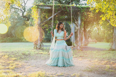 Maharani in a light blue anarkali sitting on a swing Maharani in a light blue anarkali sitting on a swing
