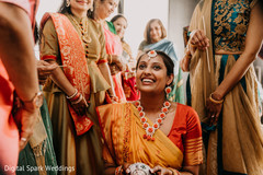 Indian relatives preparing to apply the tumeric paste on Maharani Indian relatives preparing to apply the tumeric paste on Maharani