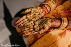 Indian bride showing her hands covered in tumeric paste Indian bride showing her hands covered in tumeric paste