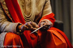 Indian groom opening a note he received Indian groom opening a note he received