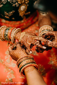 Indian relative helping the Indian bride with her jewelry Indian relative helping the Indian bride with her jewelry