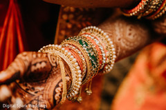 A close up to Maharani bracelets around her henna stained arms A close up to Maharani bracelets around her henna stained arms
