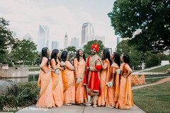 Indian groom and Indian bridesmaids laughing together Indian groom and Indian bridesmaids laughing together
