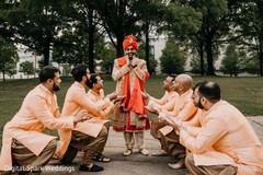Indian groomsmen kneeling before the Indian groom Indian groomsmen kneeling before the Indian groom
