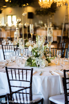 White decorations for Indian wedding reception tables. White decorations for Indian wedding reception tables.