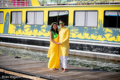 Indian couple posing outdoors on their haldi outfit. Indian couple posing outdoors on their haldi outfit.