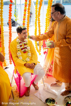Indian groom getting all smeared with yellow haldi. Indian groom getting all smeared with yellow haldi.