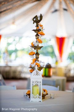 Sangeet white lantern with orange and white flowers table decor. Sangeet white lantern with orange and white flowers table decor.