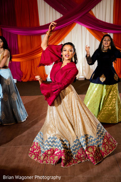 Indian bride dancing at sangeet with bridesmaids choreography. Indian bride dancing at sangeet with bridesmaids choreography.