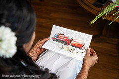 Indian bride reading grooms train card. Indian bride reading grooms train card.