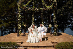 Indian couple posing outdoors on their ceremony outfits. Indian couple posing outdoors on their ceremony outfits.