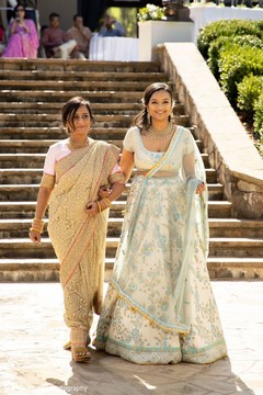 Indian bride walking to her wedding ceremony with mother. Indian bride walking to her wedding ceremony with mother.