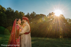 Indian bride and groom outdoors during pictures. Indian bride and groom outdoors during pictures.