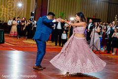 Indian couple dancing in front of the guests. Indian couple dancing in front of the guests.