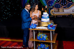 Indian couple cutting the wedding cake. Indian couple cutting the wedding cake.