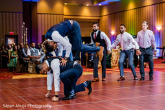 Indian groomsmen performing during the reception party. Indian groomsmen performing during the reception party.