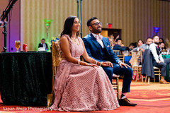 Indian couple in reception wear being amused in reception. Indian couple in reception wear being amused in reception.