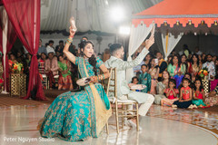 Joyful Indian couple at sangeet party shoe game. Joyful Indian couple at sangeet party shoe game.