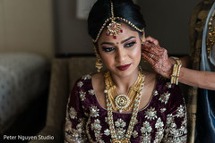Maharani getting her earings on. Maharani getting her earings on.