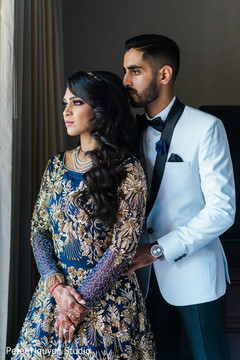 Indian couple in elegant reception outfits.