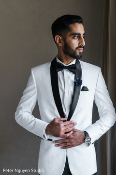 Indian groom wearing a white tux with black lapels. Indian groom wearing a white tux with black lapels.