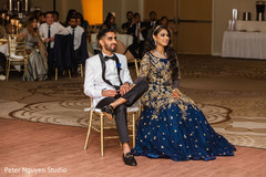 Indian couple enjoying reception performances. Indian couple enjoying reception performances.