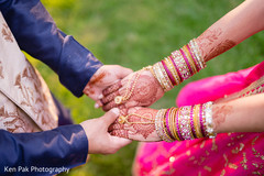 Indian groom holding his Maharani's henna stained hands Indian groom holding his Maharani's henna stained hands