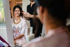 Indian bride having her hair done before the ceremony. Indian bride having her hair done before the ceremony.