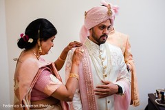 Indian groom preparing his ceremony outfit. Indian groom preparing his ceremony outfit.