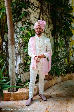 Indian groom in an elegant white sherwani and pink turban. Indian groom in an elegant white sherwani and pink turban.