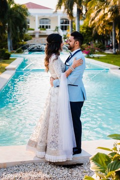 Indian couple on their reception white and light blue outfits. Indian couple on their reception white and light blue outfits.