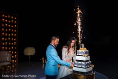Lovely capture Indian bride and groom cutting cake together. Lovely capture Indian bride and groom cutting cake together.