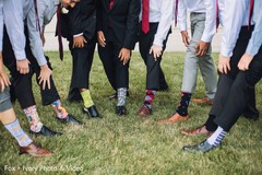 Groomsmen showing their stylish socks during pictures. Groomsmen showing their stylish socks during pictures.
