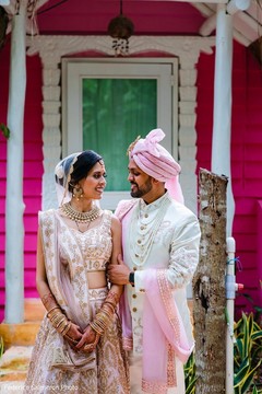 Indian bride and groom on their pink and white ceremony outfits. Indian bride and groom on their pink and white ceremony outfits.