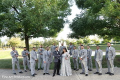Indian groom and bride posing with groomsmen. Indian groom and bride posing with groomsmen.