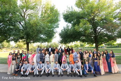 Guests posing with the couple outdoors. Guests posing with the couple outdoors.