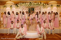 Indian bride and groom posing with special guests for pictures. Indian bride and groom posing with special guests for pictures.