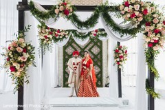 Indian couple in wedding attires and flower decorated mandap. Indian couple in wedding attires and flower decorated mandap.