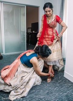 Indian bride getting help with her ceremony outfit. Indian bride getting help with her ceremony outfit.