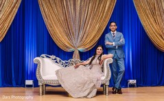 Indian bride and groom posing at their reception stage. Indian bride and groom posing at their reception stage.