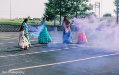 Bridesmaids with colorful smoke bombs during the baraat. Bridesmaids with colorful smoke bombs during the baraat.