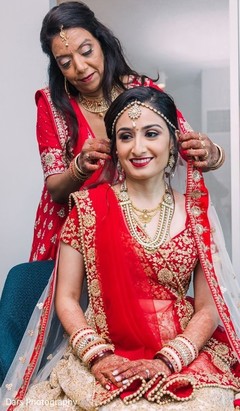 Indian bride getting her wedding white and red veil on. Indian bride getting her wedding white and red veil on.