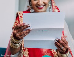 Indian bride holding grooms letter. Indian bride holding grooms letter.