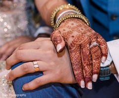Indian bride and groom showing their wedding rings. Indian bride and groom showing their wedding rings.